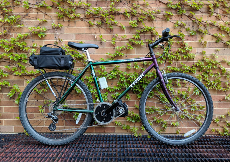 aggie e-bike leaning against a brick wall