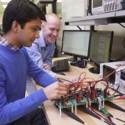 researchers looking at circuit board